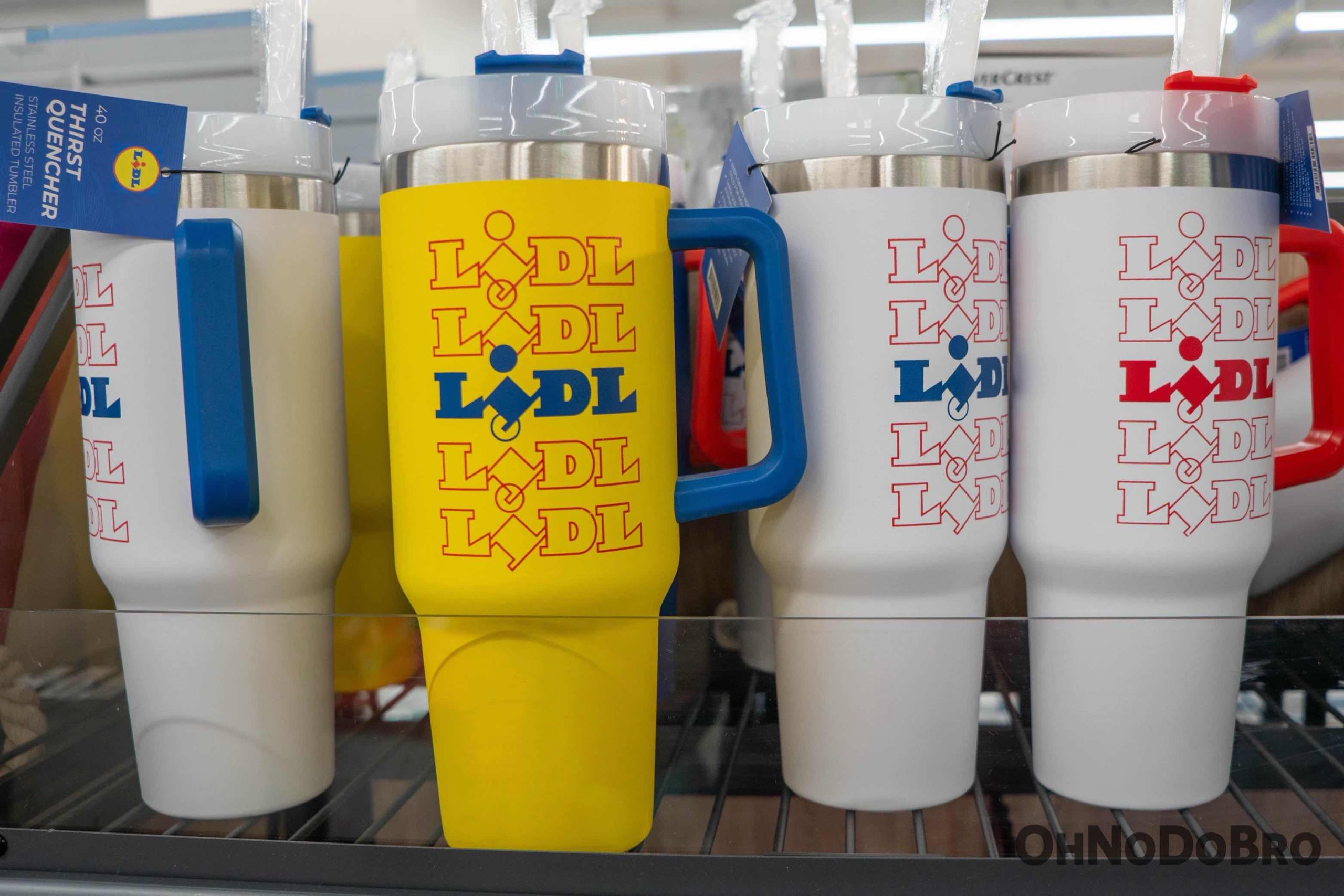 A close up of a shelf containing 4+ Lidl tumblers. All are white except one yellow tumbler in the center
